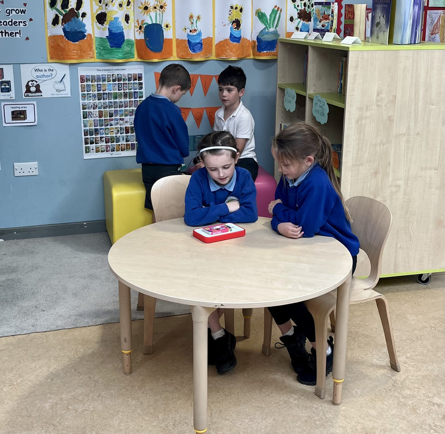 Pupils at a classroom table with a Voxblock audiobook player