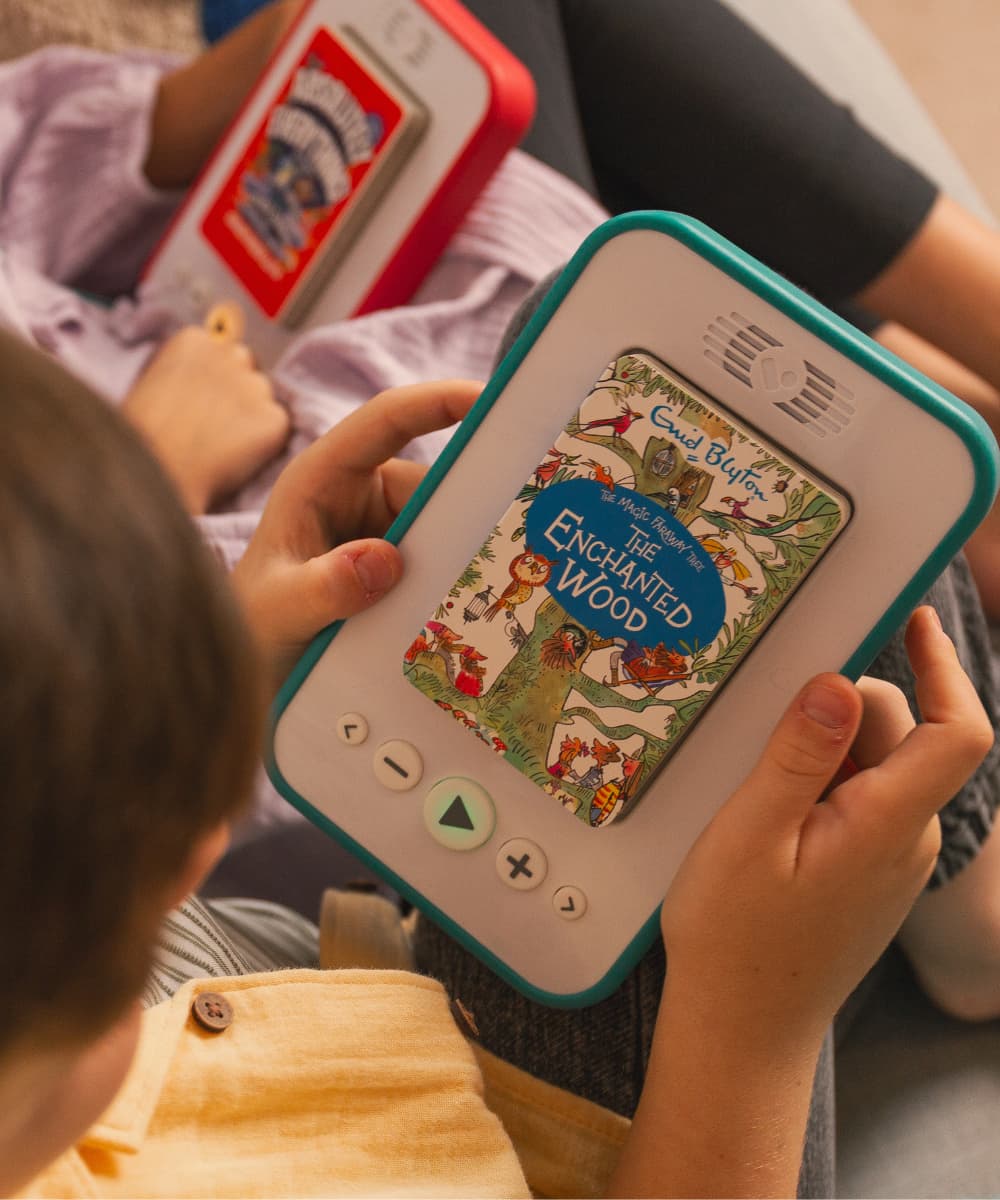 Child holding a handheld audiobook player