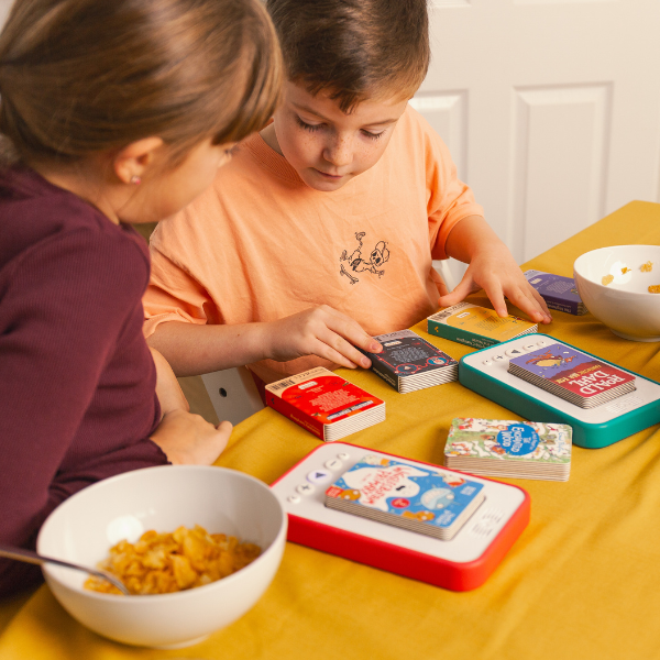 Two children looking at the back covers of Voxblock audiobooks
