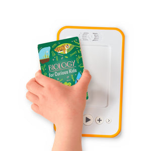 A hand holding the audiobook card for Biology for Curious Kids beside a Voxblock audiobook player