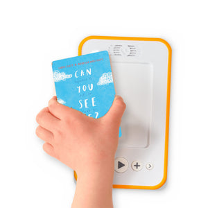 A hand holding the audiobook card for Can You See Me? beside a Voxblock audiobook player