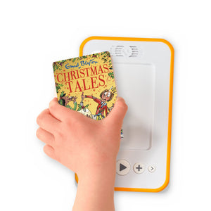 A hand holding the audiobook card for Christmas Tales beside a Voxblock audiobook player