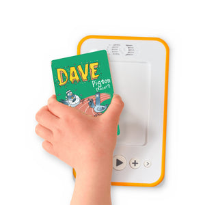 A hand holding the audiobook card for Dave Pigeon: Racer! beside a Voxblock audiobook player