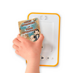 A hand holding the audiobook card for Great Inventors and Their Inventions beside a Voxblock audiobook player
