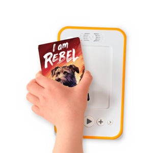 A hand holding the audiobook card for I am Rebel beside a Voxblock audiobook player