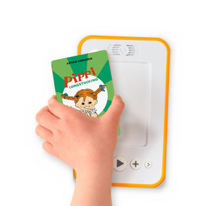 A hand holding the audiobook card for Pippi Longstocking in the South Seas beside a Voxblock audiobook player