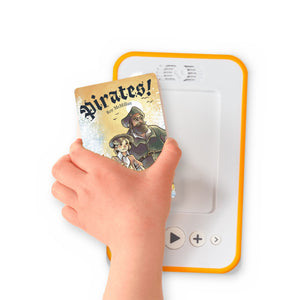 A hand holding the audiobook card for Pirates! beside a Voxblock audiobook player