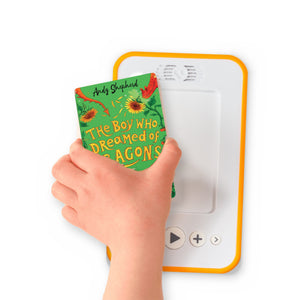 A hand holding the audiobook card for The Boy Who Dreamed of Dragons beside a Voxblock audiobook player