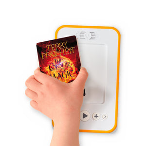A hand holding the audiobook card for The Colour of Magic beside a Voxblock audiobook player