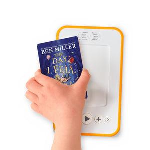 A hand holding the audiobook card for The Day I Fell into a Fairytale beside a Voxblock audiobook player