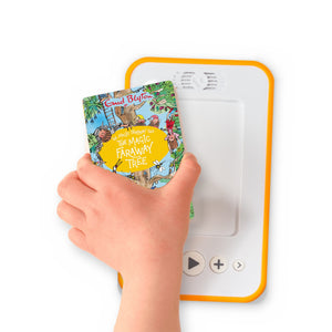 A hand holding the audiobook card for The Magic Faraway Tree beside a Voxblock audiobook player