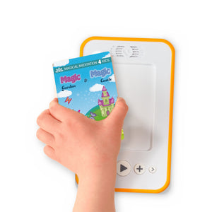 A hand holding the audiobook card for The Magic Garden & The Magic Castle beside a Voxblock audiobook player