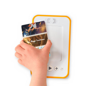 A hand holding the audiobook card for The Magic Treehouse + The Tropical Island + The Space Adventure beside a Voxblock audiobook player