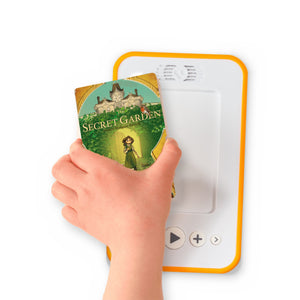 A hand holding the audiobook card for The Secret Garden beside a Voxblock audiobook player