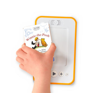 A hand holding the audiobook card for Winnie-the-Pooh beside a Voxblock audiobook player