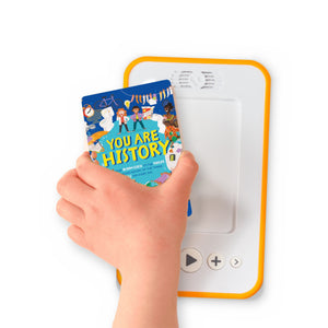 A hand holding the audiobook card for You Are History beside a Voxblock audiobook player