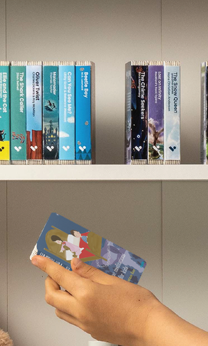 A hand taking the Bedtime Meditations for Kids audiobook from a shelf of Voxblock audiobooks