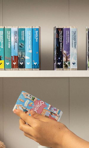 A hand taking the Hotel Flamingo audiobook from a shelf of Voxblock audiobooks