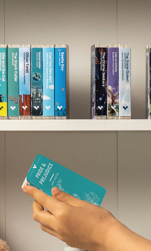 A hand taking the Pride and Prejudice audiobook from a shelf of Voxblock audiobooks