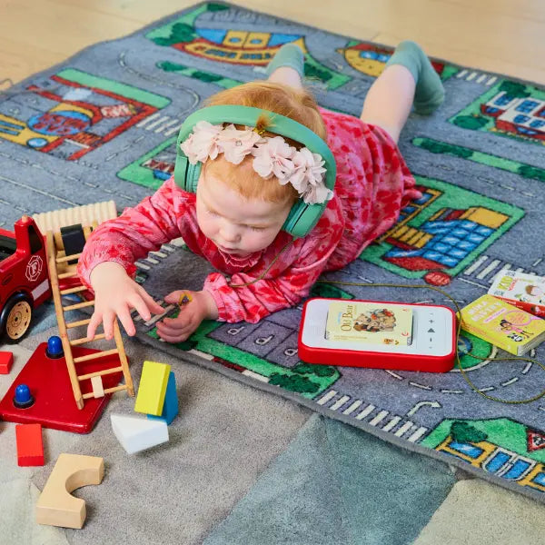 Child playing with toys on a colorful rug