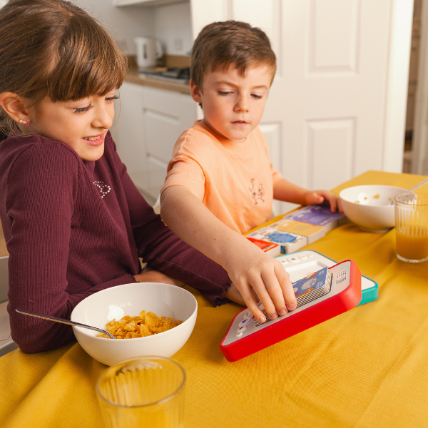 boy placing an audiobook block onto his red Voxblock device