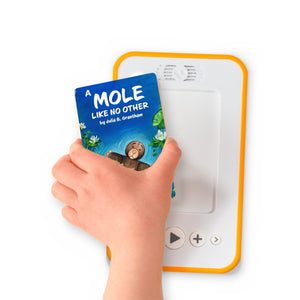 A hand holding the audiobook card for A Mole Like No Other beside a Voxblock audiobook player