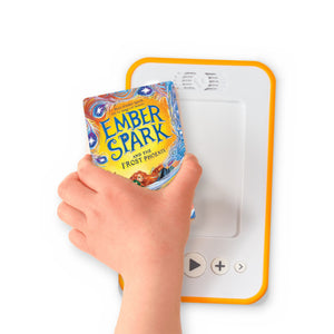 A hand holding the audiobook card for Ember Spark and the Frost Phoenix beside a Voxblock audiobook player