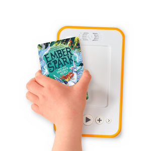 A hand holding the audiobook card for Ember Spark and the Unicorn's Secret beside a Voxblock audiobook player