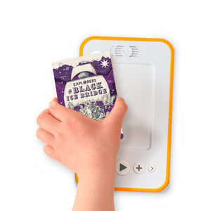 A hand holding the audiobook card for Explorers on Black Ice Bridge beside a Voxblock audiobook player