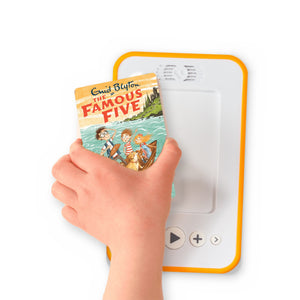 A hand holding the audiobook card for Famous Five: Five On A Treasure Island beside a Voxblock audiobook player