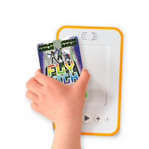 A hand holding the audiobook card for Fly High Crew: The Green Glow beside a Voxblock audiobook player