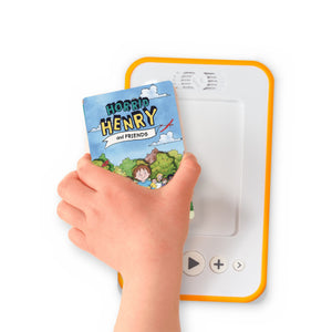 A hand holding the audiobook card for Horrid Henry and Friends beside a Voxblock audiobook player