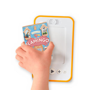 A hand holding the audiobook card for Hotel Flamingo beside a Voxblock audiobook player
