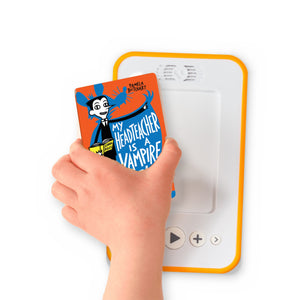 A hand holding the audiobook card for My Headteacher is a Vampire Rat beside a Voxblock audiobook player