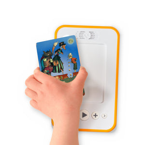 A hand holding the audiobook card for Pinocchio beside a Voxblock audiobook player