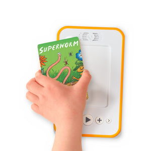 A hand holding the audiobook card for Superworm beside a Voxblock audiobook player
