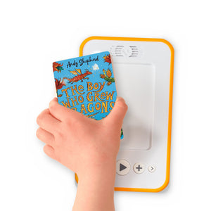 A hand holding the audiobook card for The Boy Who Grew Dragons beside a Voxblock audiobook player