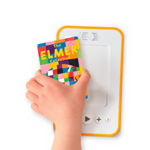 A hand holding the audiobook card for The Elmer Collection beside a Voxblock audiobook player