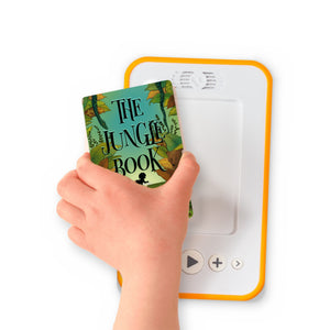 A hand holding the audiobook card for The Jungle Book beside a Voxblock audiobook player