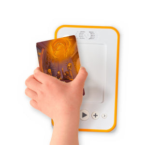 A hand holding the audiobook card for The Phoenix and the Carpet beside a Voxblock audiobook player
