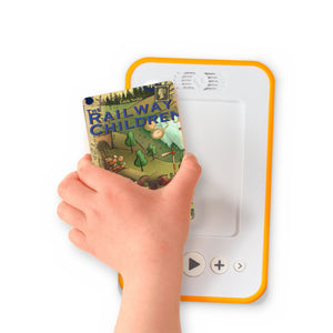 A hand holding the audiobook card for The Railway Children beside a Voxblock audiobook player
