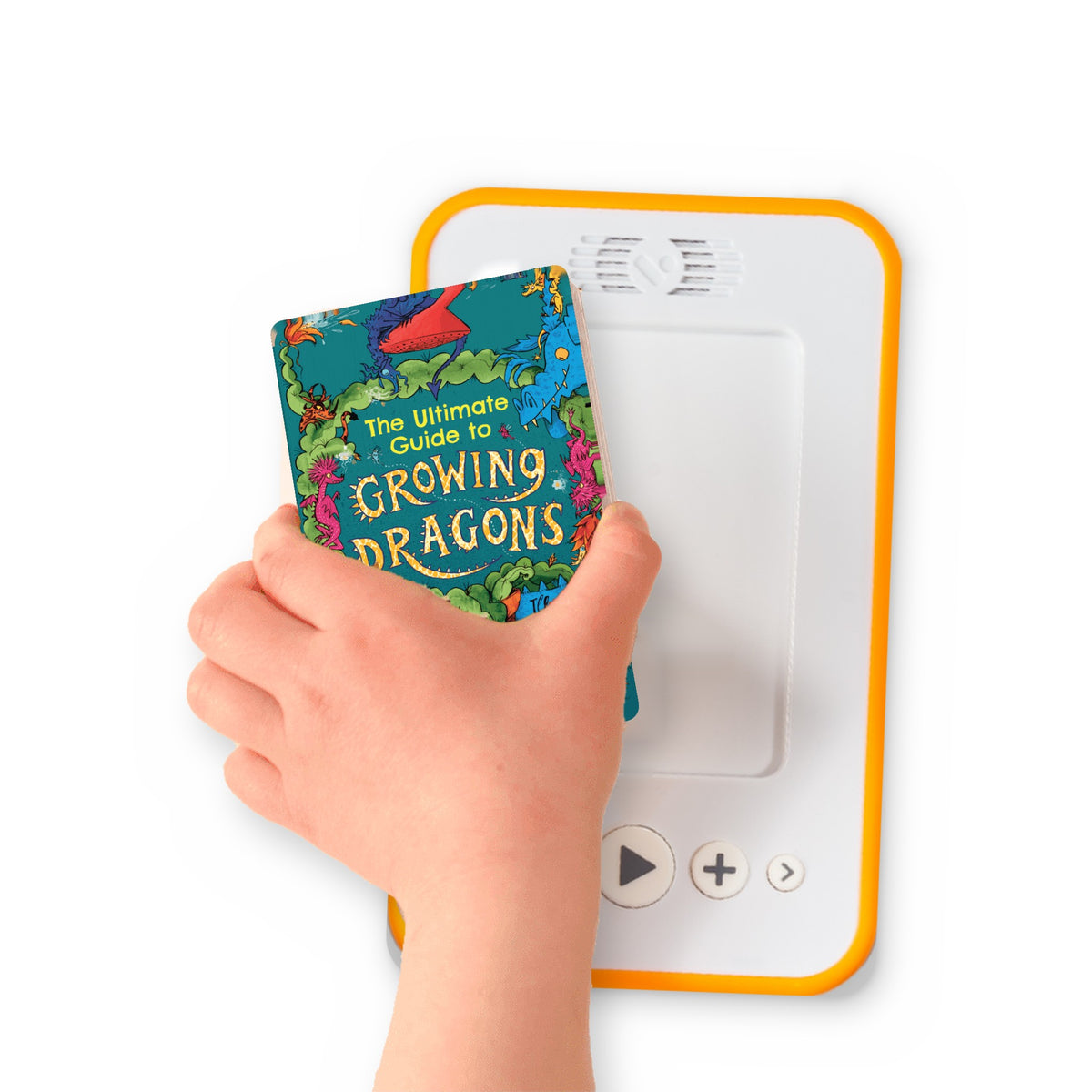 A hand holding the audiobook card for The Ultimate Guide to Growing Dragons beside a Voxblock audiobook player