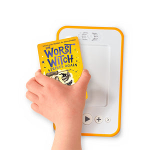 A hand holding the audiobook card for The Worst Witch Strikes Again beside a Voxblock audiobook player