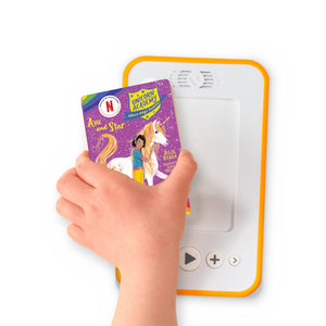 A hand holding the audiobook card for Unicorn Academy: Ava and Star beside a Voxblock audiobook player