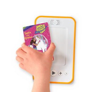 A hand holding the audiobook card for Unicorn Academy: Sophia and Rainbow beside a Voxblock audiobook player