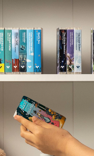 A hand taking the Alice's Adventures in Wonderland audiobook from a shelf of Voxblock audiobooks
