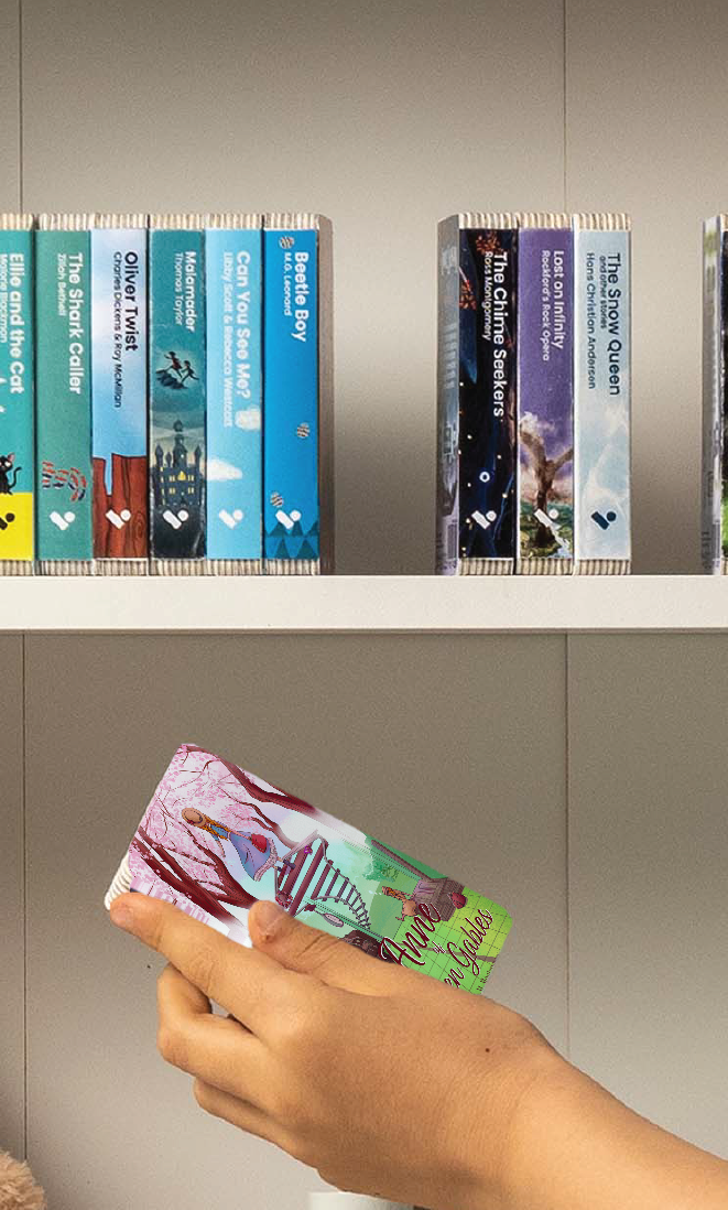 A hand taking the Anne of Green Gables audiobook from a shelf of Voxblock audiobooks