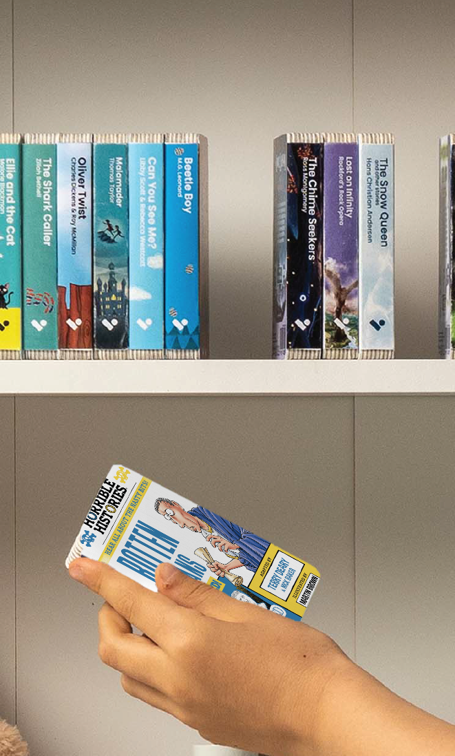 A hand taking the Horrible Histories: Rotten Romans audiobook from a shelf of Voxblock audiobooks