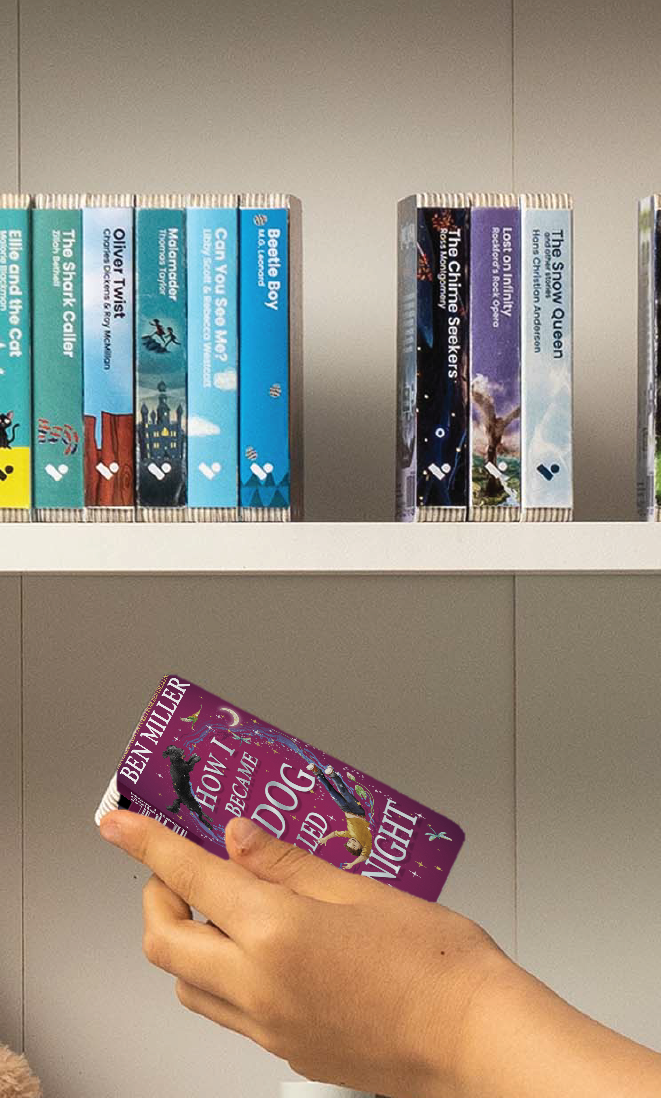 A hand taking the How I Became a Dog Called Midnight audiobook from a shelf of Voxblock audiobooks