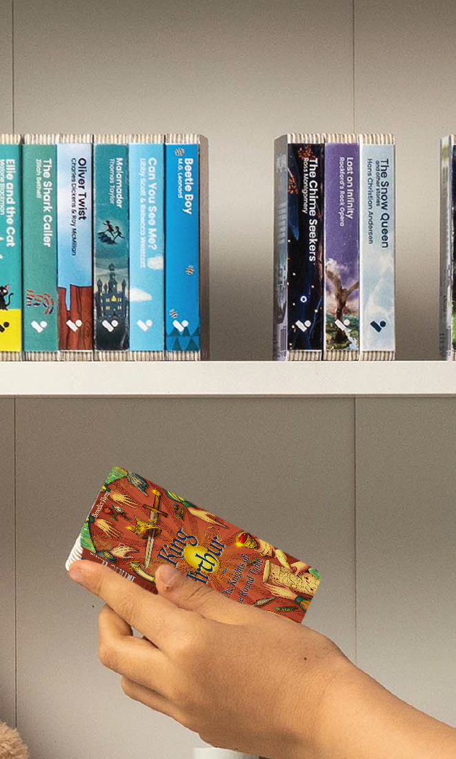 A hand taking the King Arthur & the Knights of the Round Table audiobook from a shelf of Voxblock audiobooks